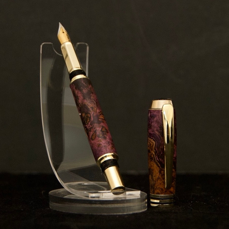 handmade fountain pen made from curly maple with dyed purple swirls and gold and black hardware
