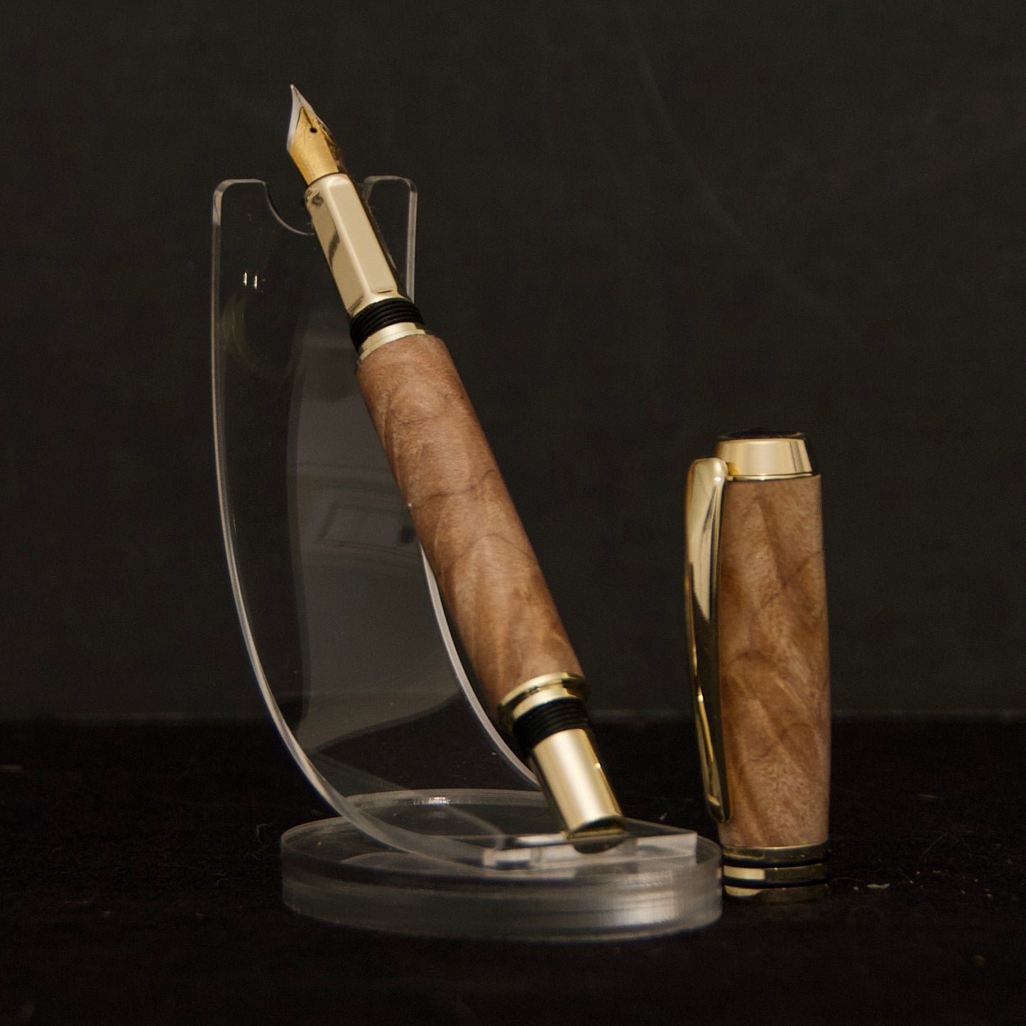 handmade fountain pen made from curly maple burl with gold and black hardware