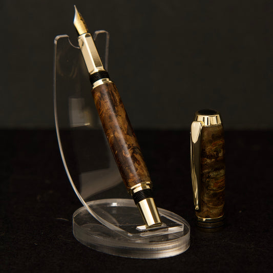 handmade fountain pen made from dark brown maple burl with gold and black hardware