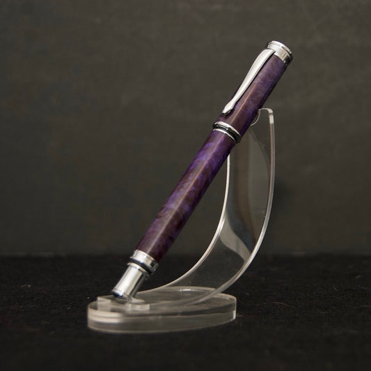 Rollerball pen with cap on, made from purple dyed maple burl, with chrome hardware